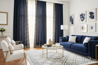 a living room with white, navy blue and light gold interior focus in curtains